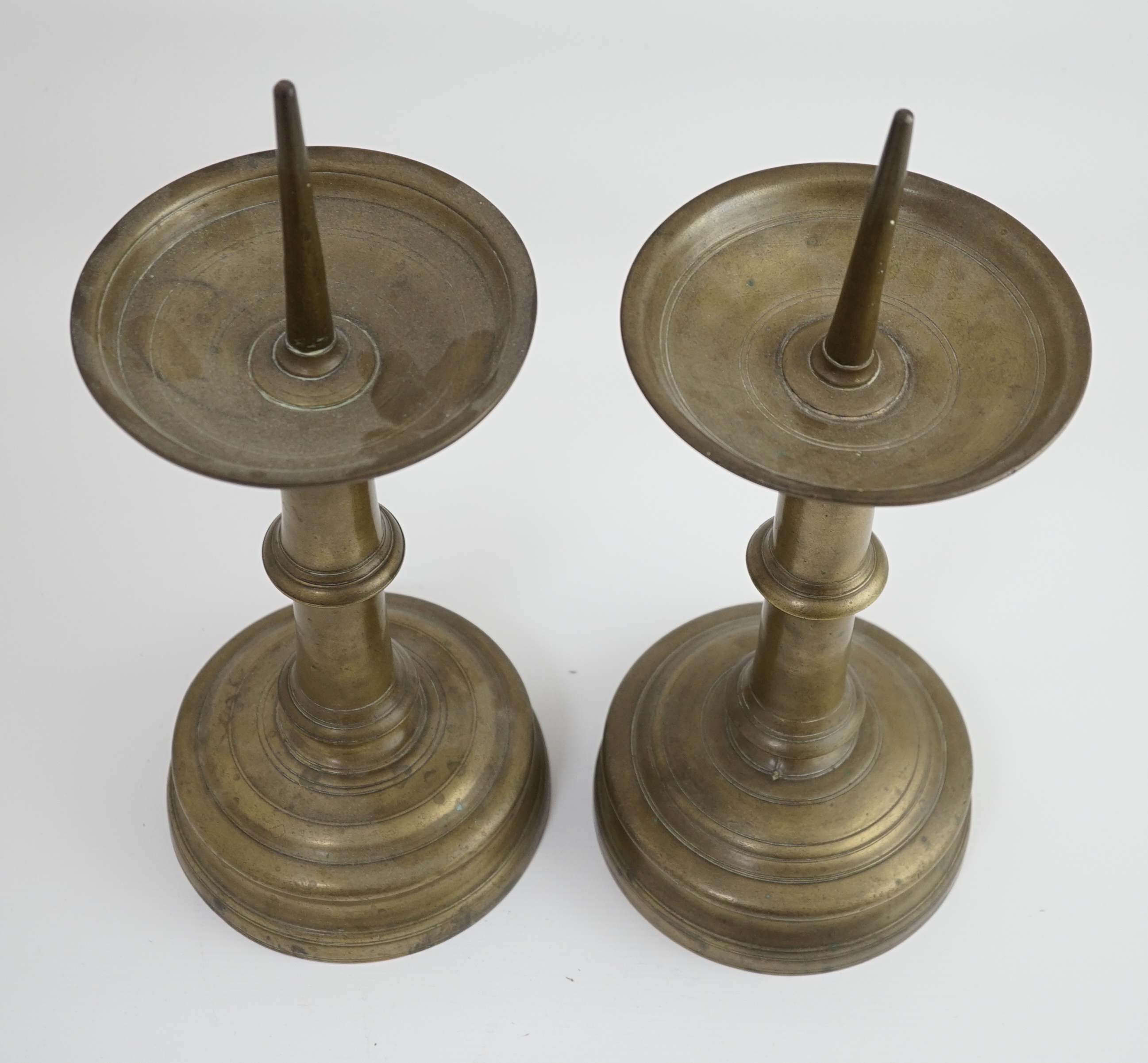 A pair of 16th century bell metal pricket candlesticks